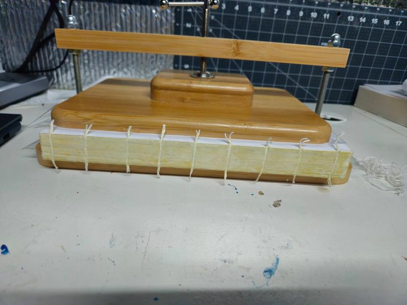 Who knew that you needed to take a saw to a stack of papers to make a book and glue the pages together with string?