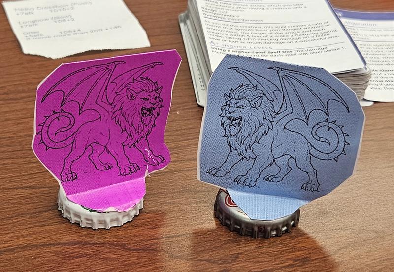 2 different colors of thermal paper printed  manticore minifigure TTRPG game pieces